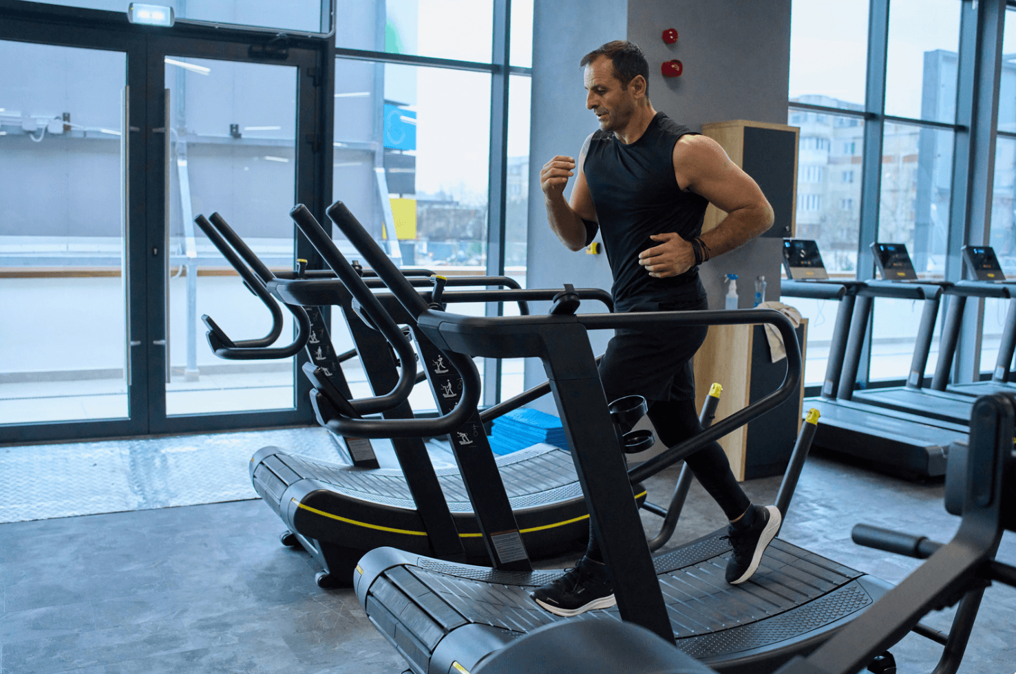 Man running on curved treadmill